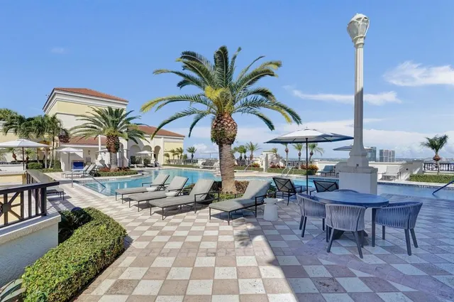 a view of a swimming pool with chairs