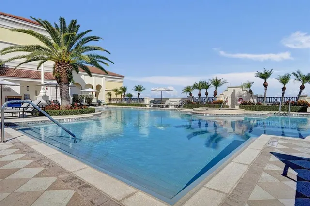 a view of swimming pool with outdoor seating and lake view