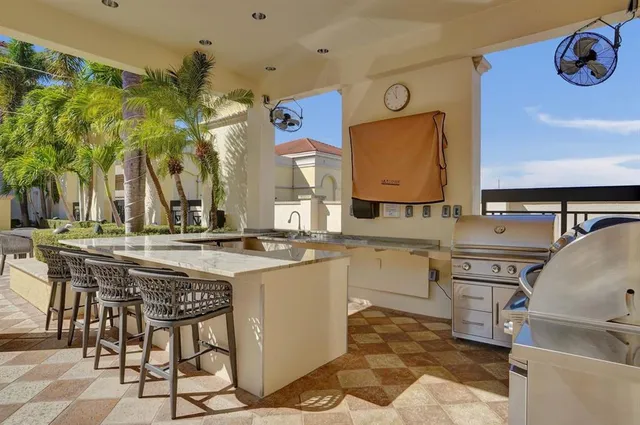 a kitchen with stainless steel appliances granite countertop a sink and cabinets