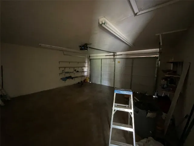 a view of a backyard with a garden and tree