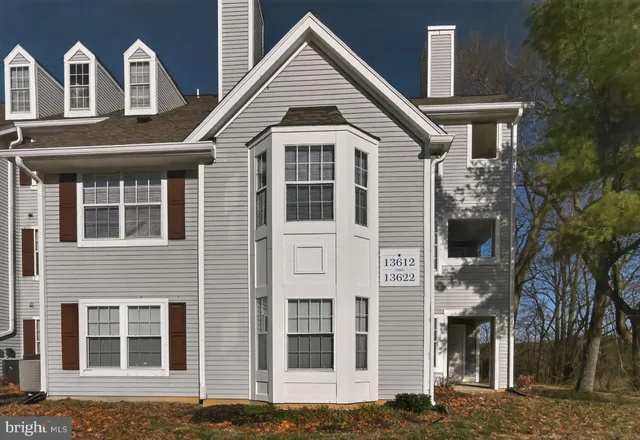 a view of a brick house with large windows