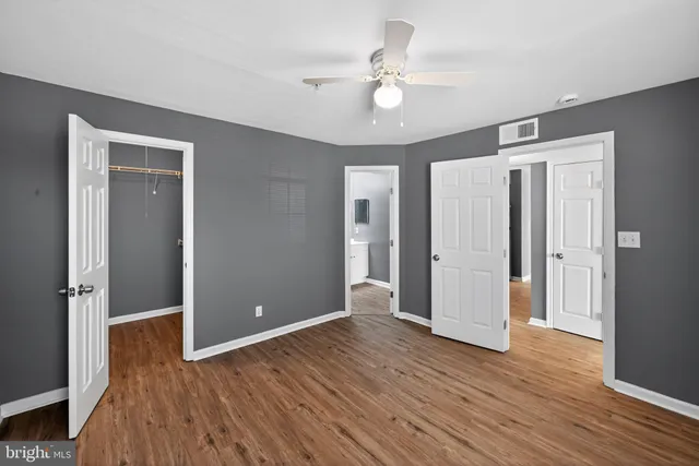 a view of an empty room with wooden floor