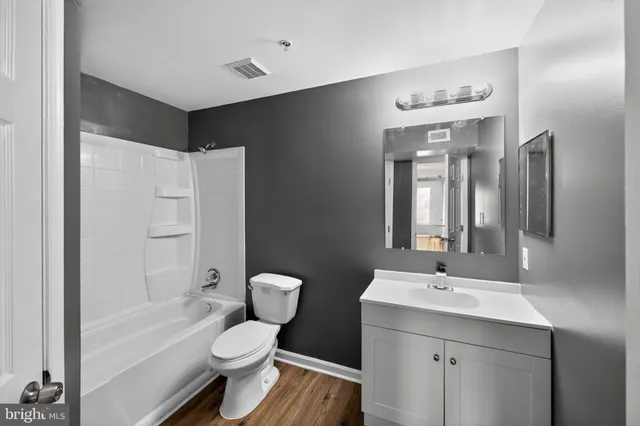 a bathroom with a sink toilet tub and shower