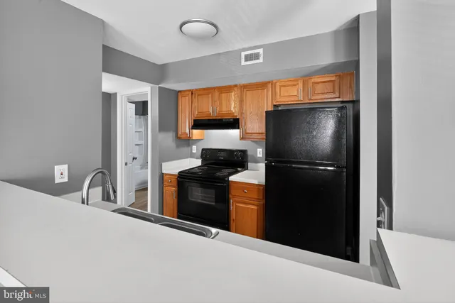 a kitchen with a refrigerator and a sink