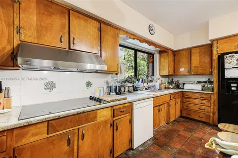 a kitchen with stainless steel appliances granite countertop a sink a stove and a refrigerator