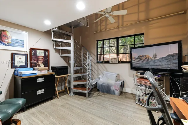 a room with wooden furniture and windows