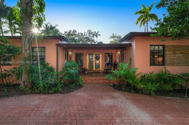 a view of house with garden and plants