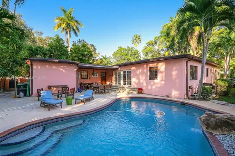 a front view of house with yard swimming pool and furniture