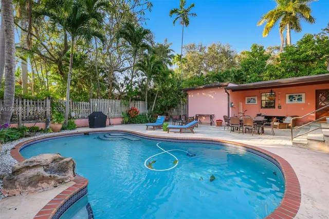 swimming pool view with a seating space