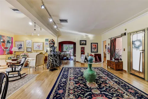 a living room with lots of furniture and wooden floor