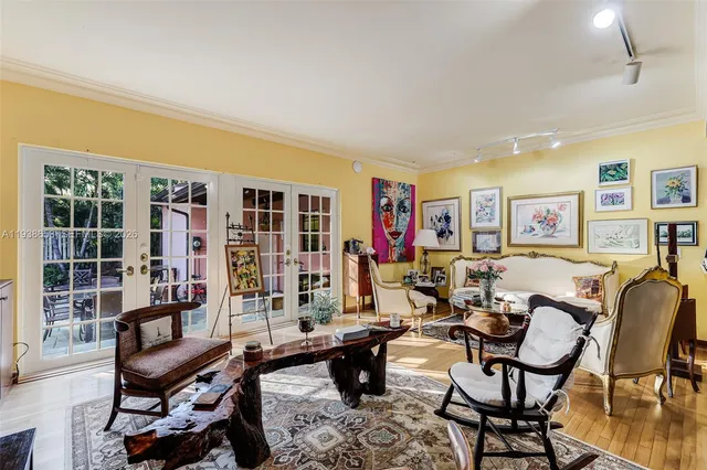 a living room with furniture a bookshelf and a window