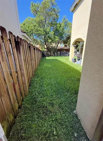 a view of a wall with a wall clock and white walls