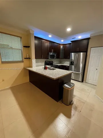 a kitchen with a sink and a refrigerator