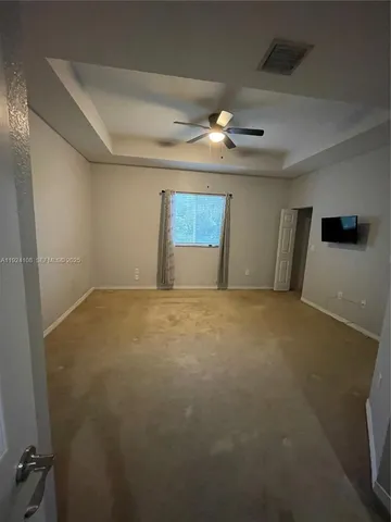 a view of a backyard with a small cabin and a chair