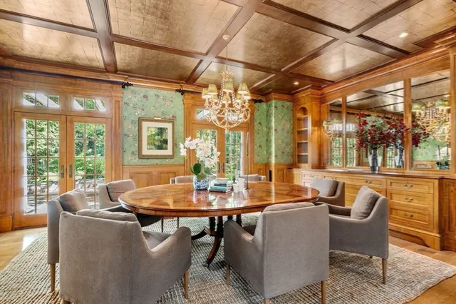 a living room with furniture a fireplace and wooden floors