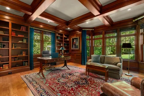 a living room with furniture a fireplace and a table with wooden floor