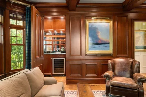 a living room with furniture wooden floor and a window