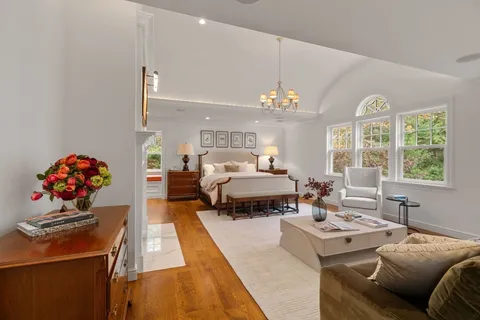 a spacious bathroom with a granite countertop sink a toilet a mirror and vanity