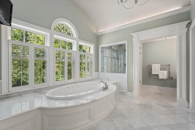 a bedroom with a bed and large window