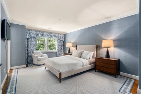 a view of staircase with railing and frames on wall