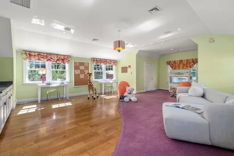a living room with furniture gym equipment and a window