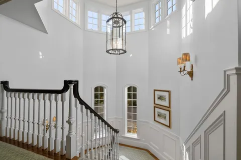 a room with gym equipment and wooden floor
