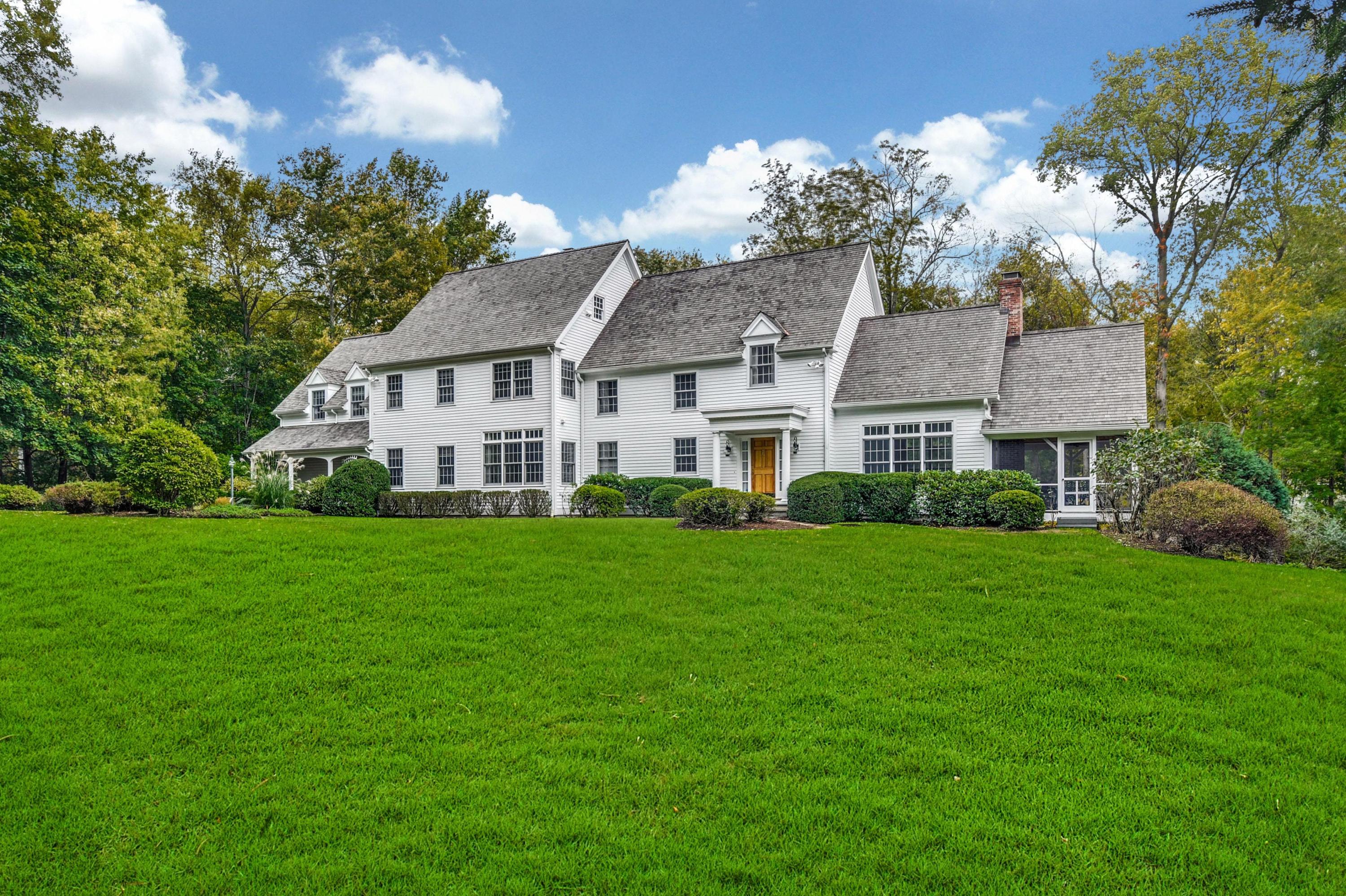 a aerial view of a house with a big yard and large trees