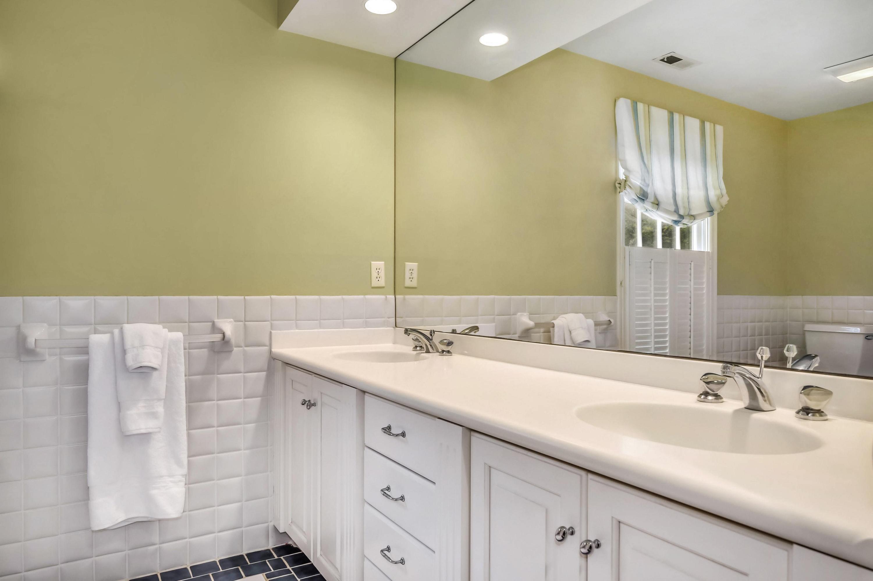 104 Christie Hill Road Darien, CT 06820 - Photo 20 of 38 a bathroom with a double vanity sink and a mirror