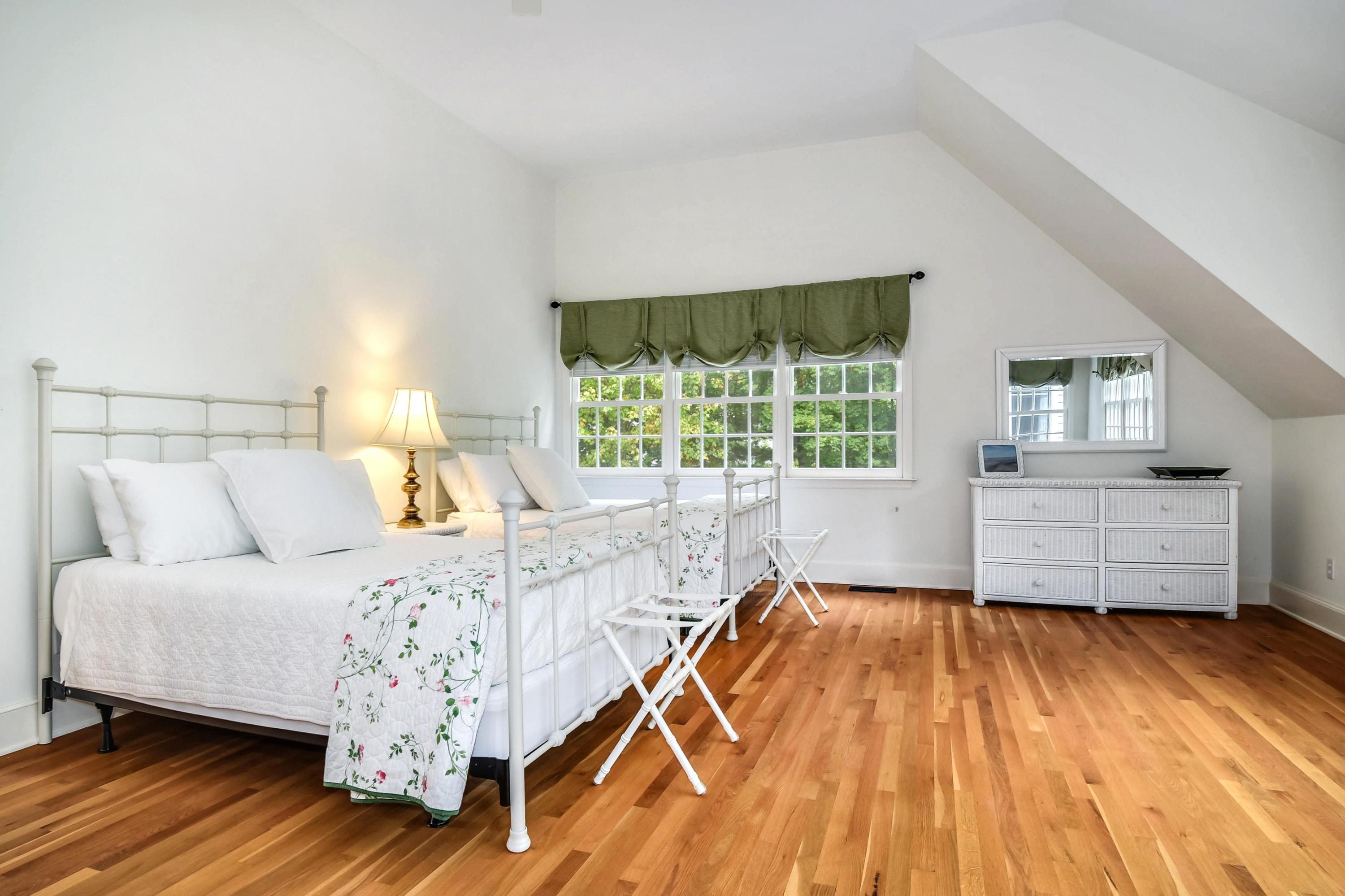 104 Christie Hill Road Darien, CT 06820 - Photo 22 of 38 a bedroom with a bed and wooden floor