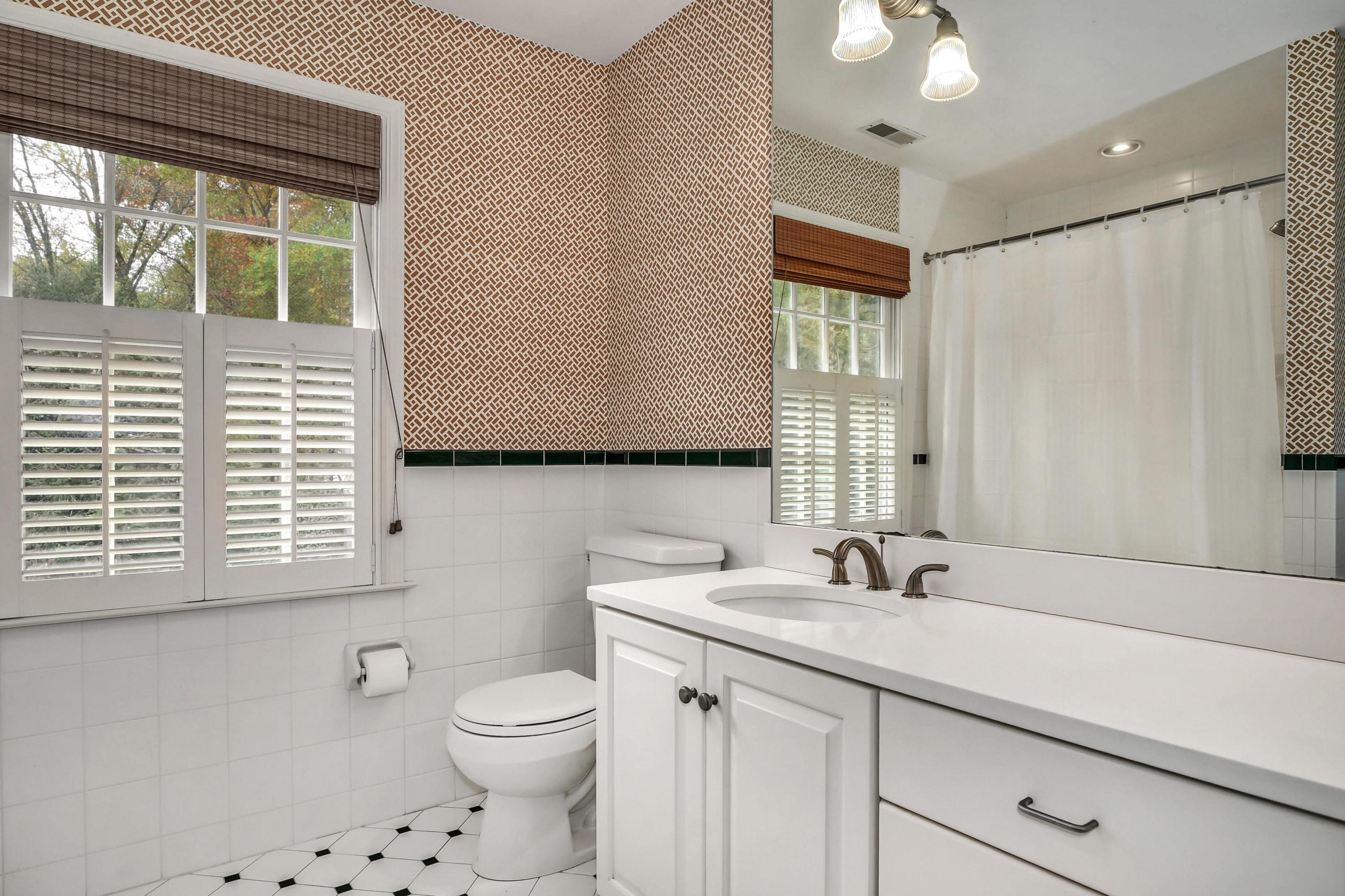 104 Christie Hill Road Darien, CT 06820 - Photo 27 of 38 a bathroom with a toilet a sink a mirror a window and vanity