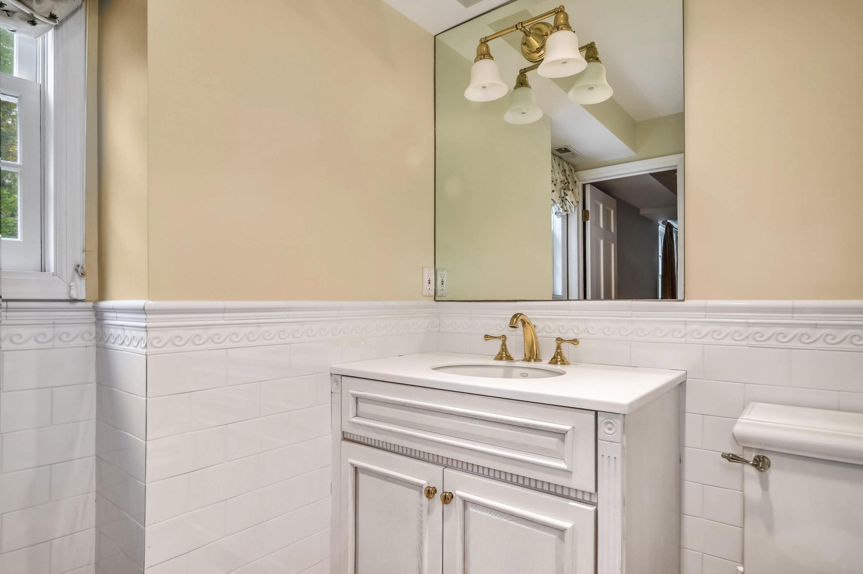 104 Christie Hill Road Darien, CT 06820 - Photo 31 of 38 a bathroom with a sink vanity and a mirror