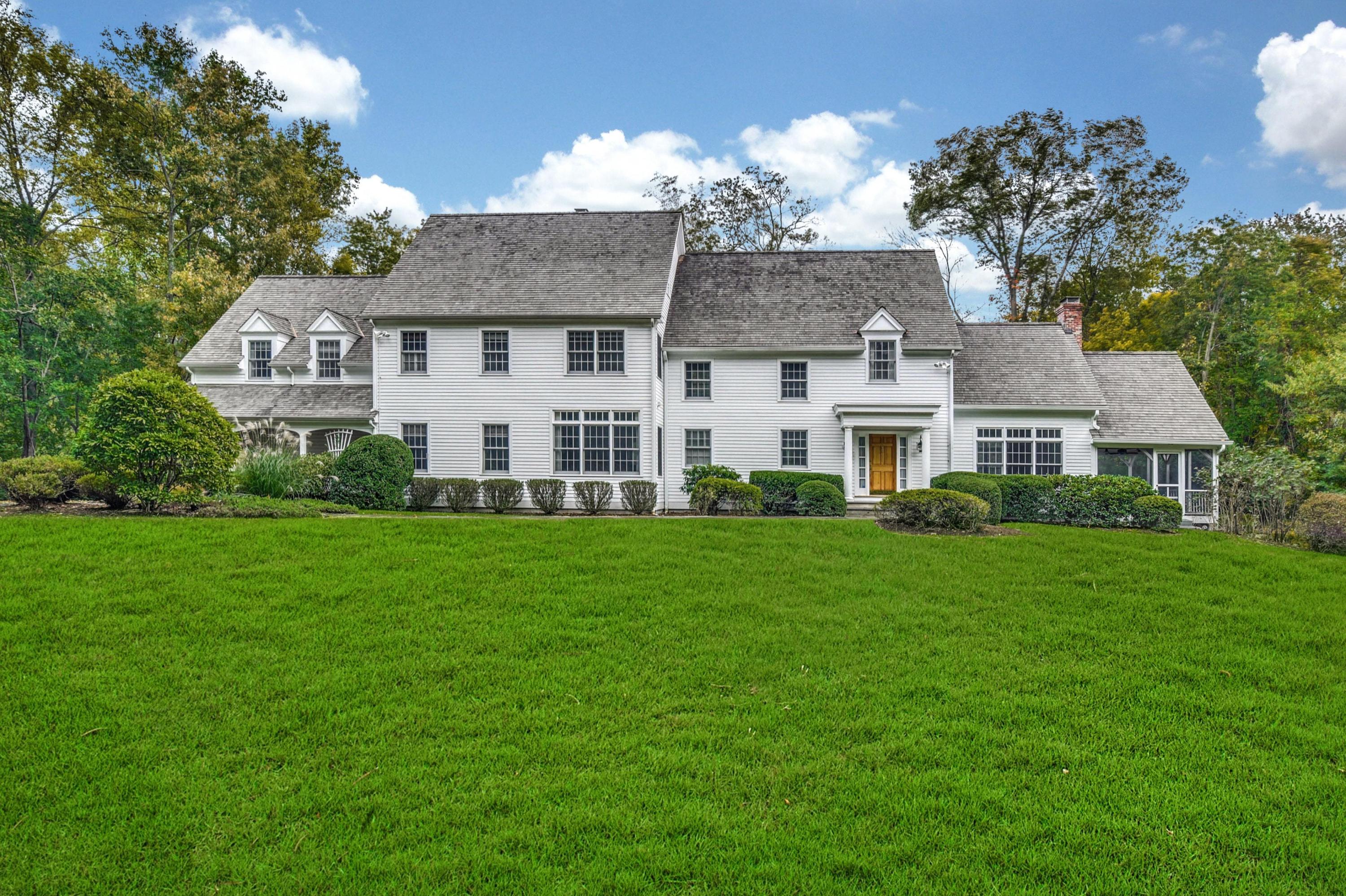 104 Christie Hill Road Darien, CT 06820 - Photo 35 of 38 a front view of a house with a garden