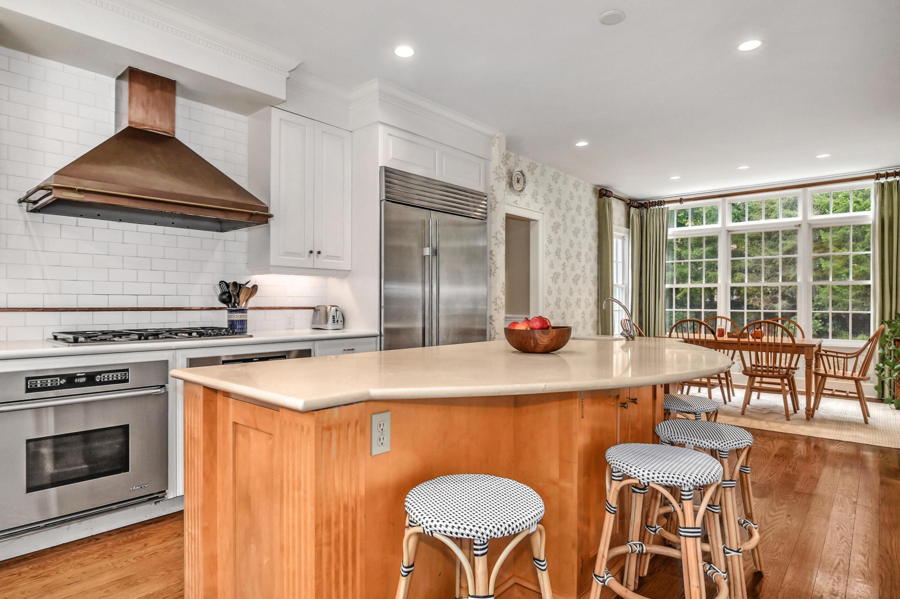 104 Christie Hill Road Darien, CT 06820 - Photo 10 of 38 a kitchen with stainless steel appliances a sink a stove a table and chairs