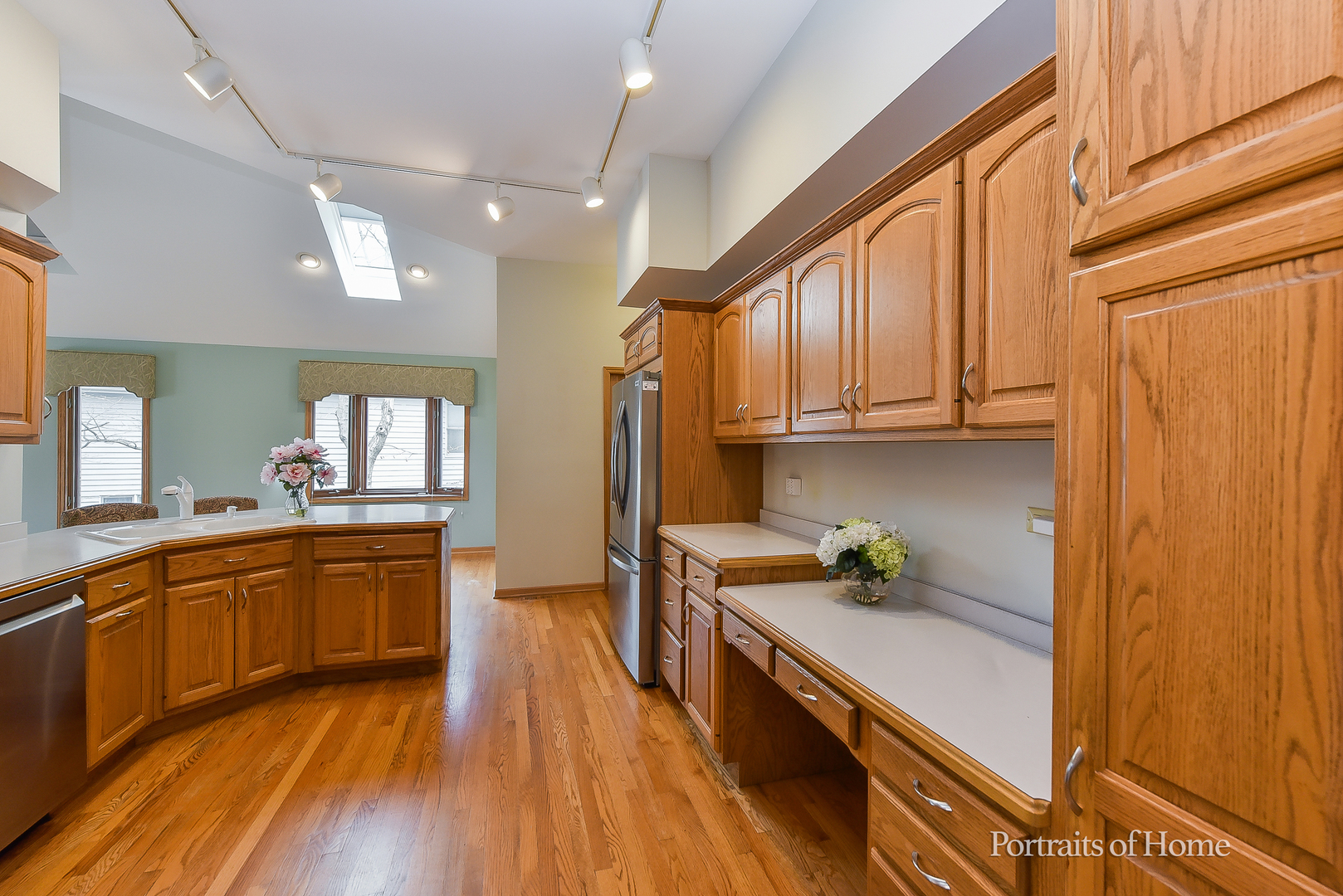 11 Merrimack Court Bolingbrook, IL 60440 - Photo 13 of 46 a kitchen with stainless steel appliances granite countertop wooden cabinets a sink and dishwasher