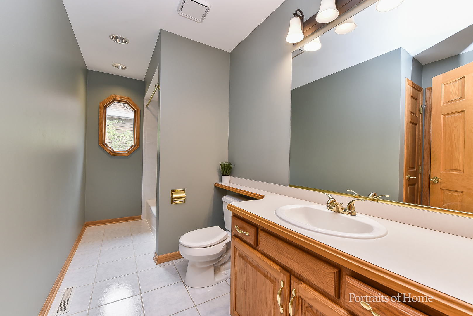 11 Merrimack Court Bolingbrook, IL 60440 - Photo 24 of 46 a bathroom with a toilet sink vanity and mirror