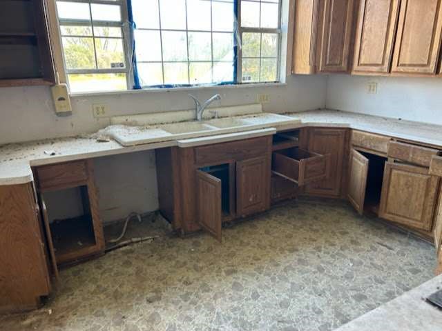 1314 Sixth Street Angleton, TX 77515 - Photo 4 of 11 a kitchen with a sink stove and cabinets