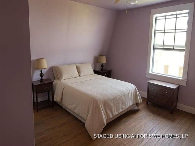 1314 Sixth Street Angleton, TX 77515 - Photo 7 of 11 a bed sitting in a bedroom next to a window