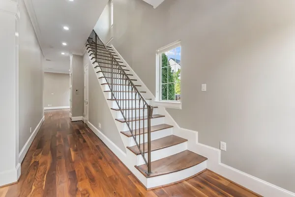 a view of entryway with wooden floor and stairs