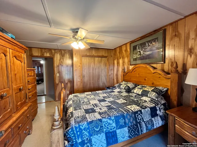 a bedroom with bed and a chair