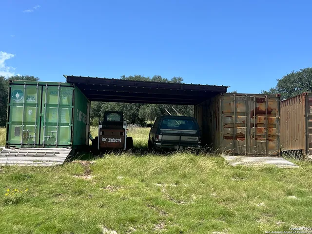 a view of a green field with lots of bushes