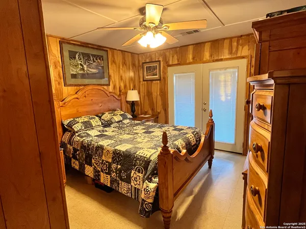 a bedroom with a bed and a chandelier