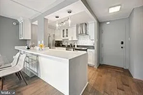 a kitchen with a sink cabinets and wooden floor