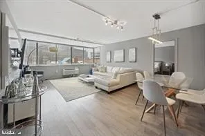 a bedroom with furniture and a large window