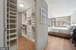 1325 18th Street Northwest, Unit 703 Washington, DC 20036 - Photo 5 of 10 a bedroom with a bed and a view of walk in closet