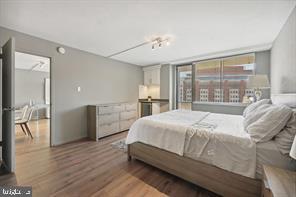 1325 18th Street Northwest, Unit 703 Washington, DC 20036 - Photo 6 of 10 a bedroom with a bed and a large window