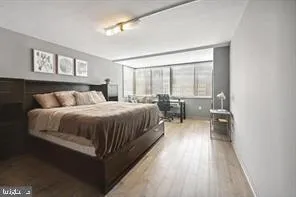 a bedroom with a bed and glass window