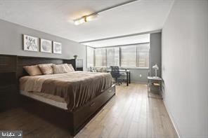 1325 18th Street Northwest, Unit 703 Washington, DC 20036 - Photo 9 of 10 a bedroom with a bed and glass window