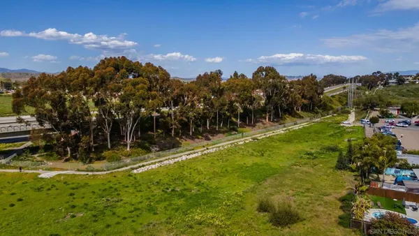 an aerial view of a residential houses with outdoor space