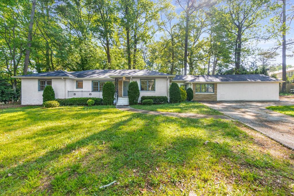 a view of a house with a patio and a yard