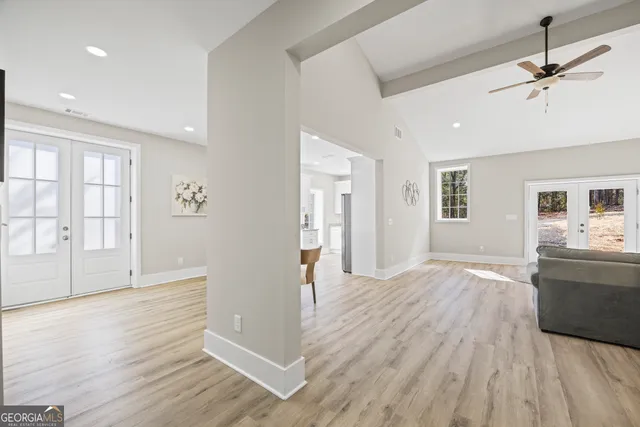 a living room with furniture and a hard wood floor